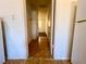 View from kitchen into hallway with tiled floor and carpeted adjacent room at 615 Harrison Ave, Las Vegas, NV 89106