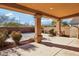 Covered patio with access to backyard and landscaping at 8001 Pavarotti Ave, Las Vegas, NV 89178