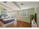 Main bedroom with wood floors, fireplace and sliding glass doors at 8001 Pavarotti Ave, Las Vegas, NV 89178