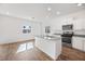 Open kitchen with island, stainless steel appliances, and grey countertops at 6455 Cinnamon Hazelnut St, North Las Vegas, NV 89084