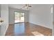 Bright bedroom with sliding glass door to backyard and dark laminate flooring at 6231 Texas Crude St, North Las Vegas, NV 89081