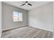 Spacious bedroom with grey wood-look flooring and ceiling fan at 5601 Mary Lou St, Pahrump, NV 89061