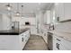 Modern kitchen with white cabinets, a large island, and marble countertops at 5601 Mary Lou St, Pahrump, NV 89061