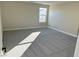 Spacious bedroom with grey carpet and a window at 1041 Ferodale Ave, North Las Vegas, NV 89084