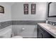 Small bathroom with penny tile, dark vanity, and framed artwork at 6540 W Cougar Ave, Las Vegas, NV 89139