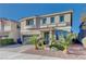 Two-story house with landscaped front yard, gray exterior, and a teal front door at 6540 W Cougar Ave, Las Vegas, NV 89139