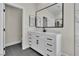 Bathroom with modern white vanity, black hardware, and gray tile floors at 8125 Sunset Cove Dr, Las Vegas, NV 89128