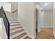 Modern staircase with wood and white risers, metal railing, and light-colored flooring at 8125 Sunset Cove Dr, Las Vegas, NV 89128