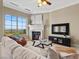 Bright living room featuring a fireplace, large windows, and comfortable seating at 20 Via Visione # 105, Henderson, NV 89011