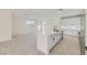 Modern kitchen with white cabinets, a large island, and light grey wood-look flooring at 9742 Rocket Grove Ct, Las Vegas, NV 89178