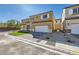 Two-story house with tan exterior, white shutters, and a brick driveway at 9742 Rocket Grove Ct, Las Vegas, NV 89178