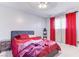 Bedroom with red bedding, nightstands, and red curtains at 153 Pecos Way, Las Vegas, NV 89121