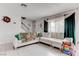 Living room with white sectional sofa and a staircase at 153 Pecos Way, Las Vegas, NV 89121