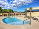 Kidney shaped pool with lounge chairs at 5365 E Volterra Dr, Pahrump, NV 89061