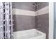 Bathroom with shower/tub combo and gray tile at 2485 Paradise Village Way # 0, Las Vegas, NV 89120