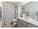 Clean bathroom with grey vanity, shower/tub combo and patterned shower curtain at 3652 Wild Willow St, Las Vegas, NV 89129