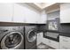 Laundry room with modern appliances and custom cabinetry at 1228 Stellar Rim Ct, Henderson, NV 89012