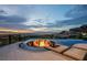 Luxury pool with fire pit and city views at sunset at 1228 Stellar Rim Ct, Henderson, NV 89012