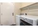 Convenient laundry room with washer, dryer, and storage at 6304 Legend Falls St, North Las Vegas, NV 89081