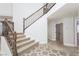 Elegant staircase with wood railing and tile flooring at 5452 Big Sky Ln, Las Vegas, NV 89149