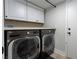 Bright laundry room with modern LG washer and dryer, white cabinets, and ample counter space at 5452 Big Sky Ln, Las Vegas, NV 89149