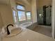 Elegant bathroom with a soaking tub, walk-in shower, and large window at 2825 Westwind Rd, Las Vegas, NV 89146