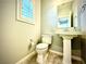 Powder room with pedestal sink and tile flooring at 6639 Ivory Dove Ct, Las Vegas, NV 89148