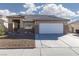 Single story home with a two-car garage and gravel landscaping at 3630 Newton Falls St, North Las Vegas, NV 89032