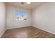 Well-lit bedroom with wood-look floors and a window at 3630 Newton Falls St, North Las Vegas, NV 89032