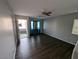 Living room with dark laminate flooring and ceiling fan at 10413 Coyote Cub Ave, Las Vegas, NV 89129