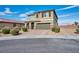 Two-story house with a two-car garage and landscaped front yard at 3008 Chiefs Ct, North Las Vegas, NV 89032