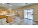 Open kitchen with island, wood cabinets, and view to backyard at 26 Drawback St, Henderson, NV 89012