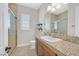 Spacious bathroom with granite countertop, wooden cabinets, and shower at 4093 San Franchesca Ct, Las Vegas, NV 89141