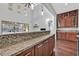 Kitchen with granite countertops, wood cabinets, and island at 4093 San Franchesca Ct, Las Vegas, NV 89141