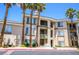 Attractive 3-story building with palm trees and ample parking at 7147 S Durango Dr # 302, Las Vegas, NV 89113