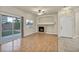 Living room features a fireplace, wood-look floors, and sliding glass door to backyard at 6041 Riverwalk Falls St # 102, North Las Vegas, NV 89031