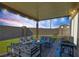 Covered patio with seating area, fire pit, and grill at 7741 Markarian St, North Las Vegas, NV 89084