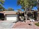 Single story home with attached garage and landscaped yard at 8612 Desert Holly Dr, Las Vegas, NV 89134