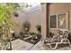 Small, private patio with lush landscaping and seating at 8612 Desert Holly Dr, Las Vegas, NV 89134