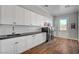 Laundry room with white cabinets, washer, dryer, and sink at 4900 N Miller Ln, Las Vegas, NV 89149