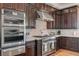 Gourmet kitchen with dark wood cabinets and stainless steel appliances at 4900 N Miller Ln, Las Vegas, NV 89149