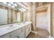 Bathroom with dual sink vanity, striped walls, and tiled flooring at 4045 Abernethy Forest Pl, Las Vegas, NV 89141