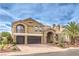 Beautiful two-story home exterior with stone accents and a balcony at 4045 Abernethy Forest Pl, Las Vegas, NV 89141