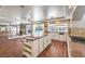 Kitchen with white cabinetry, granite countertops, wood-look floors and view to backyard pool at 4045 Abernethy Forest Pl, Las Vegas, NV 89141