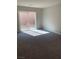 Bright bedroom with sliding glass doors leading to backyard at 7053 Parrot Bay Way, Las Vegas, NV 89118