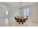 Bright dining area featuring a round wooden table and stylish modern lighting fixture at 330 Values Cir, Henderson, NV 89011