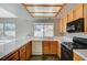 View of kitchen with wood cabinets, tile counters, and black appliances at 1509 Heather Ridge Rd, North Las Vegas, NV 89031