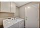 Laundry room with washer, dryer, and cabinets at 1509 Heather Ridge Rd, North Las Vegas, NV 89031