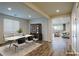 Bright dining room with an oval table and modern chairs, open to living area at 1530 Washburn St, Boulder City, NV 89005