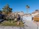 Single-story house with a spacious yard and palm trees at 6980 Wedgewood Way, Las Vegas, NV 89147